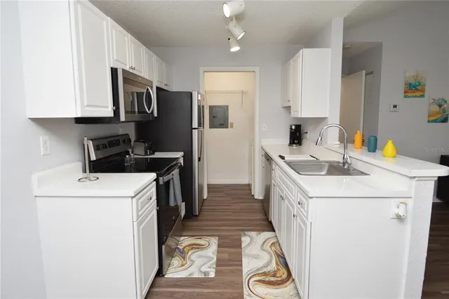 a kitchen with a dining table chairs and a microwave