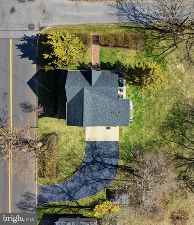 an aerial view of a house with a yard