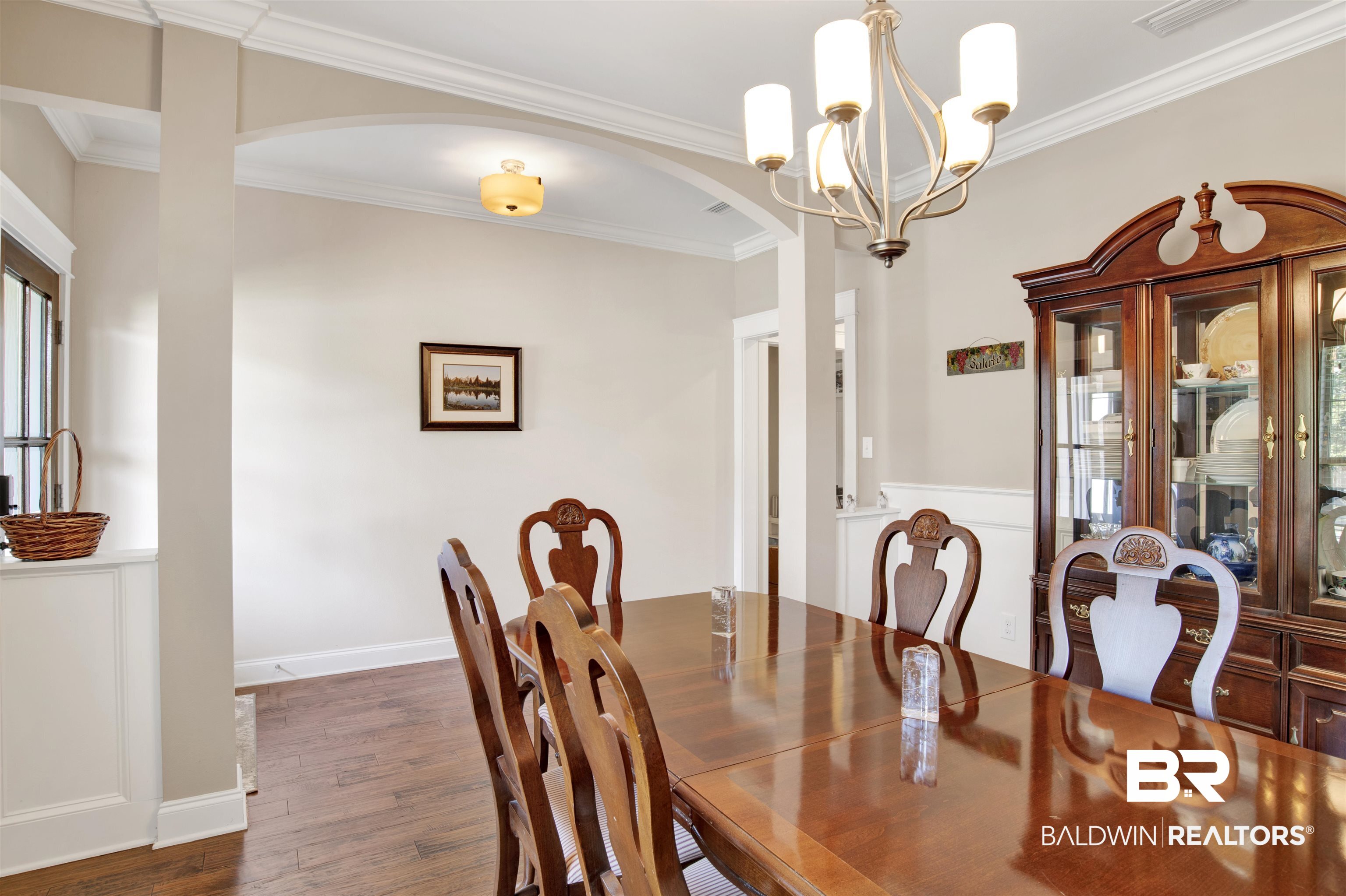360 Scarlett Avenue Fairhope, AL 36532 - Photo 8 of 34 Dining area with an inviting chandelier, dark hardwood / wood-style floors, and ornamental molding