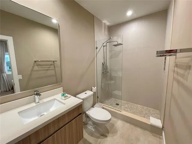 a bathroom with a sink toilet and shower