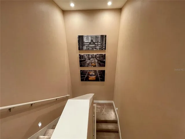 a view of a hallway with paintings on the wall