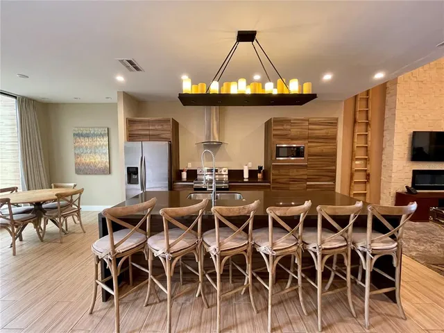 a view of a dining room with furniture wooden floor and chandelier