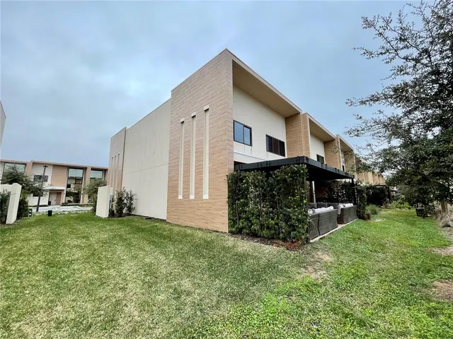 a view of a house with a yard and sitting area