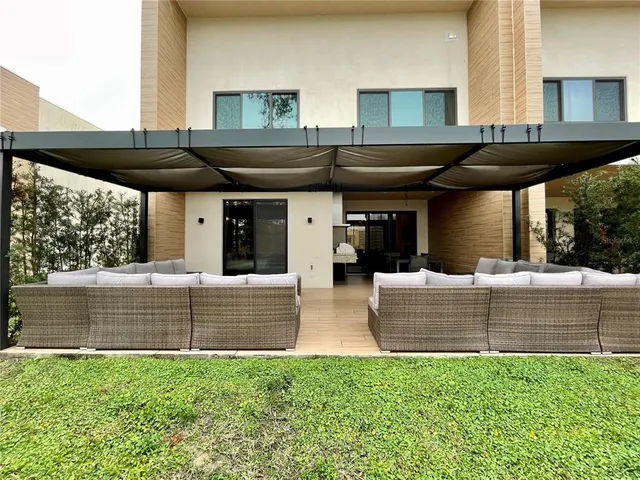 a view of outdoor kitchen with a table and chairs