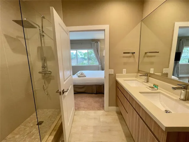 a en suite bathroom with a sink a mirror and a shower