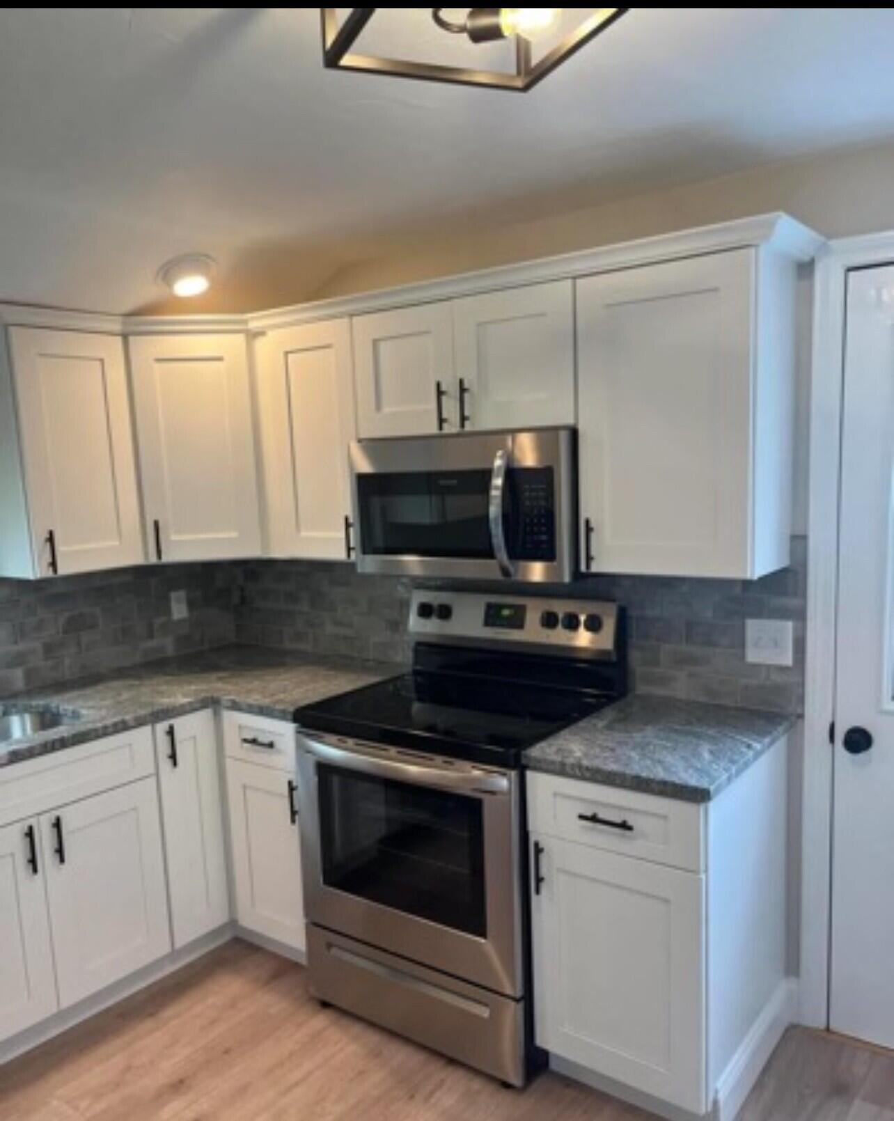 407 Orleans Road, Unit B Chatham, MA 02650 - Photo 8 of 16 a kitchen with a stove and a microwave