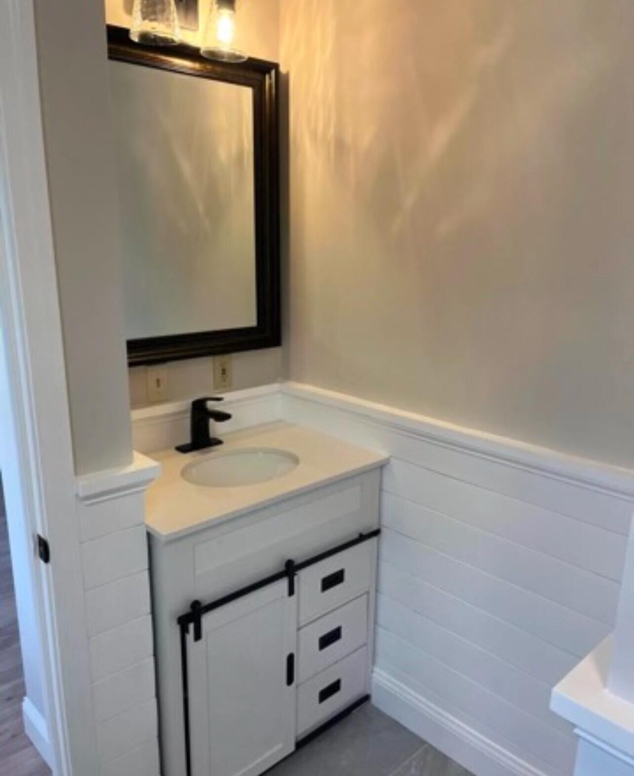 407 Orleans Road, Unit B Chatham, MA 02650 - Photo 10 of 16 a bathroom with a sink and a mirror