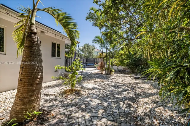 a backyard of a house with table and chairs