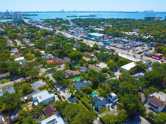 an aerial view of a residential houses with yard