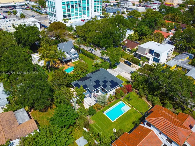 an aerial view of residential houses with outdoor space and street view