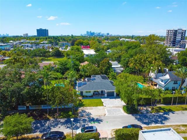 a bedroom with bed and a large window