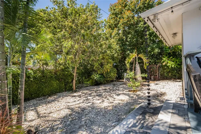 an aerial view of a house with a yard and pool