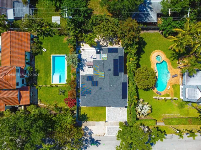 a bathroom with a sink a toilet a mirror and shower
