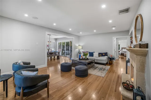 a living room with furniture and a wooden floor