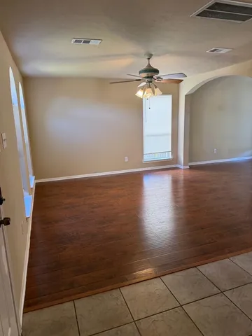 a view of a house with a yard and a large tree