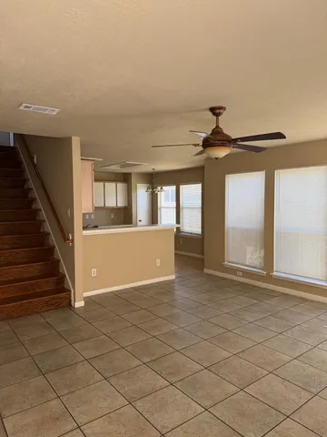 a view of room with wooden floor and fan
