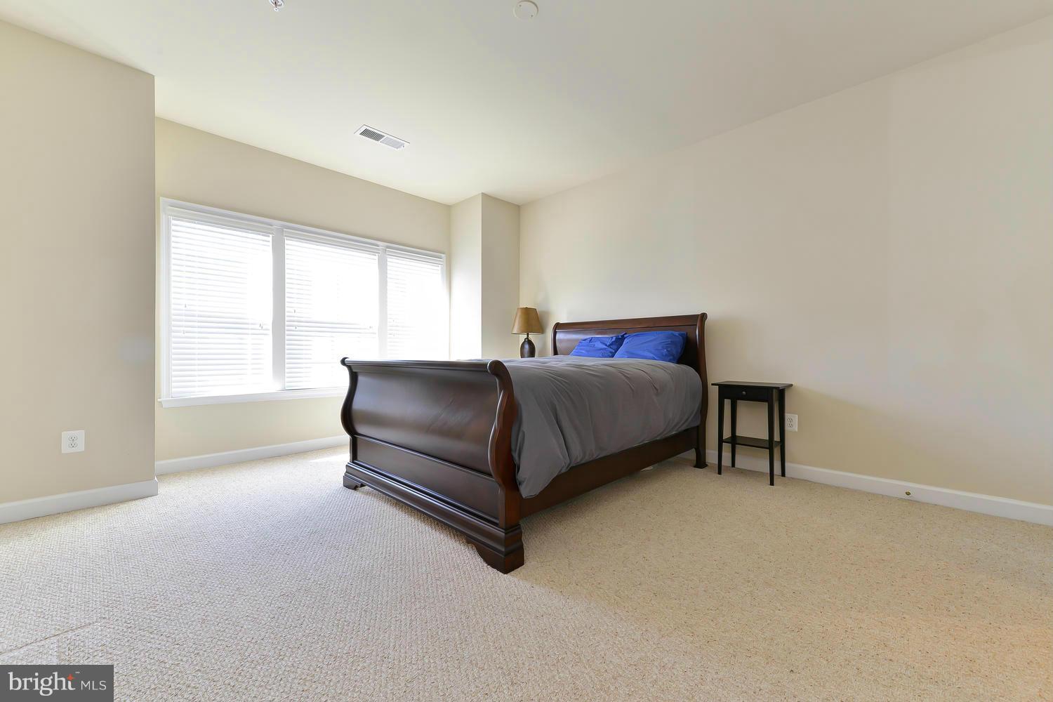 8017 Sport View Road Landover, MD 20785 - Photo 13 of 30 a bedroom with a bed lamp and window
