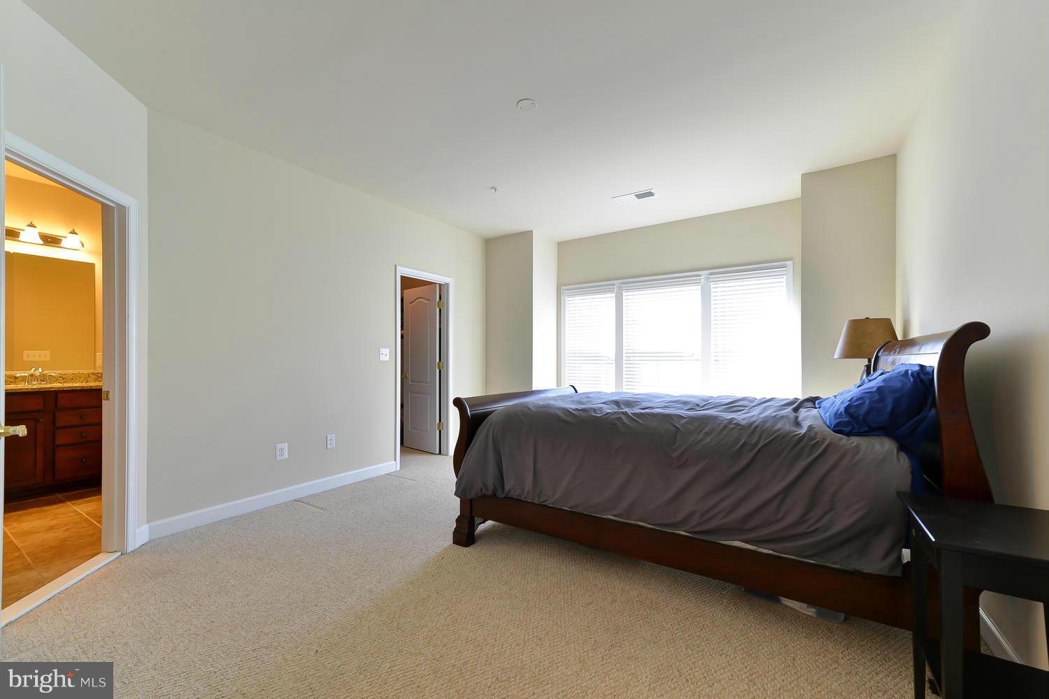 8017 Sport View Road Landover, MD 20785 - Photo 14 of 30 a bed sitting in a spacious bedroom next to a window