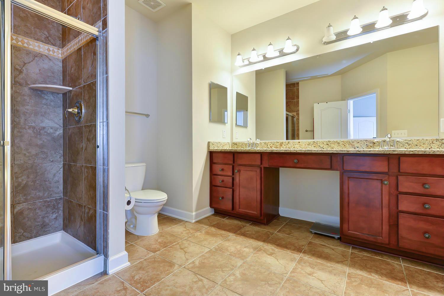 8017 Sport View Road Landover, MD 20785 - Photo 15 of 30 a spacious bathroom with a granite countertop sink mirror and toilet
