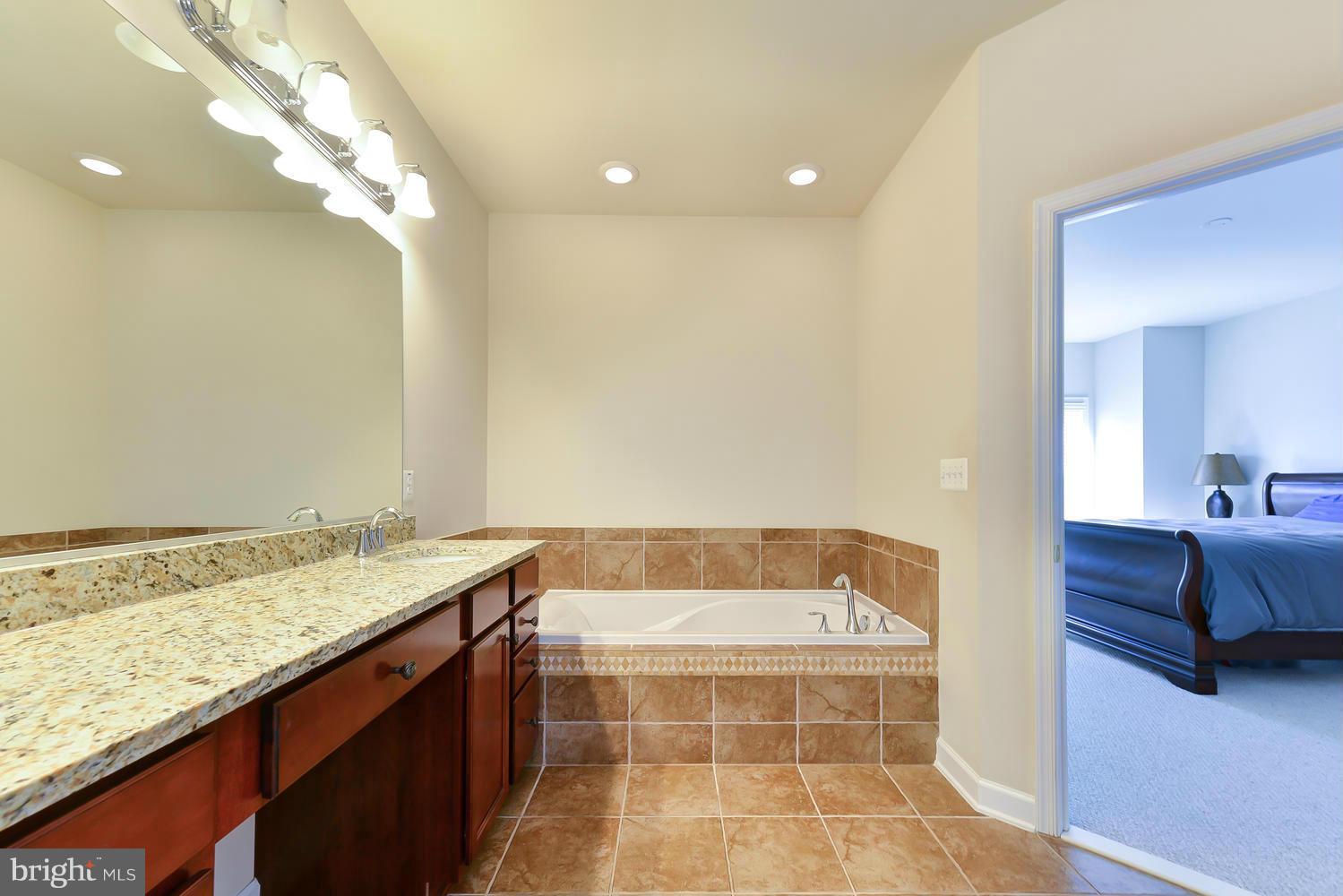 8017 Sport View Road Landover, MD 20785 - Photo 16 of 30 a bathroom with a tub sink and vanity