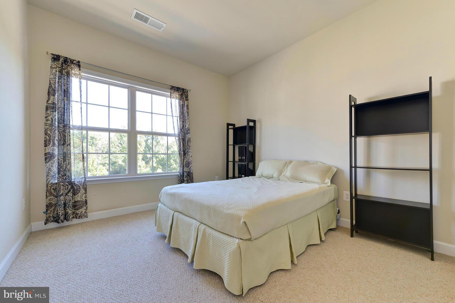 8017 Sport View Road Landover, MD 20785 - Photo 18 of 30 a bedroom with a bed and a window