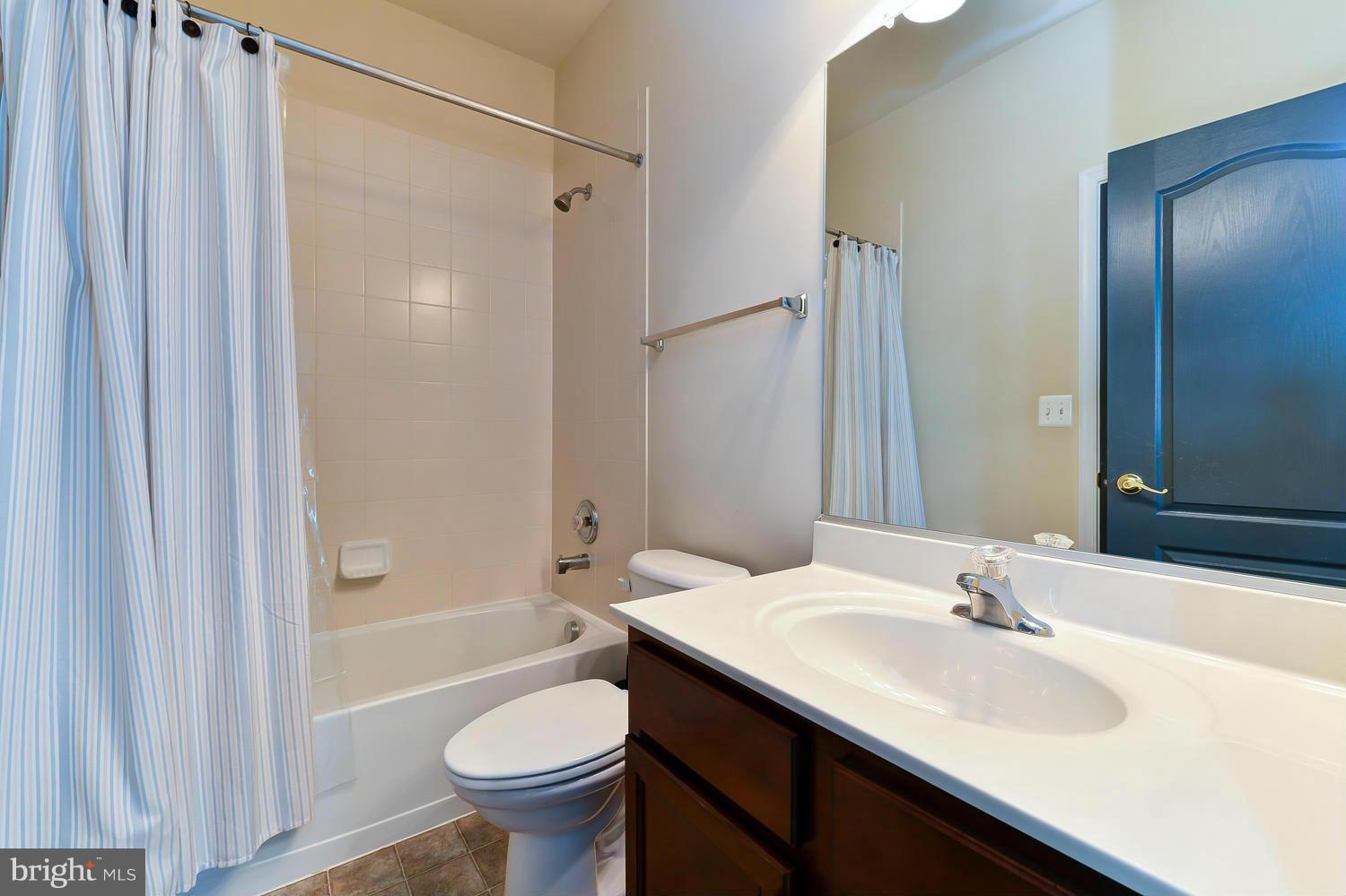 8017 Sport View Road Landover, MD 20785 - Photo 24 of 30 a bathroom with a granite countertop sink toilet and shower