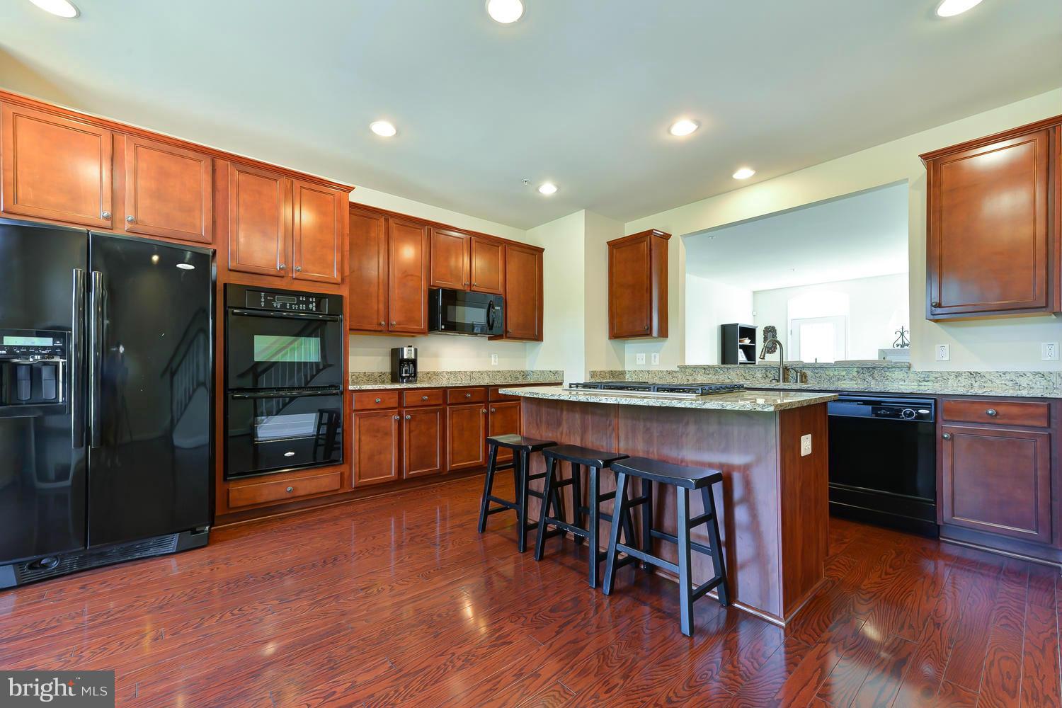 8017 Sport View Road Landover, MD 20785 - Photo 8 of 30 a kitchen with stainless steel appliances granite countertop a refrigerator a stove top oven and a sink