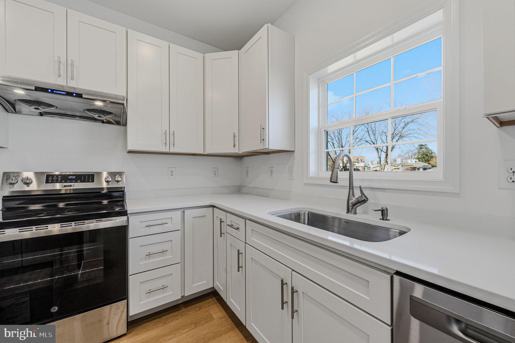 2503 A Duncan Road Wilmington, DE 19808 - Photo 15 of 39 a kitchen with white cabinets and a stove top oven