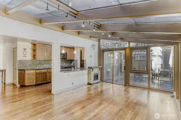 a hallway with wooden floors and chandelier
