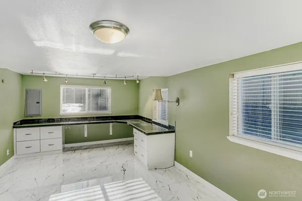 a kitchen with granite countertop a sink and a stove