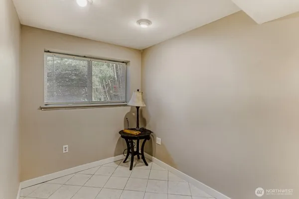 a view of a room with wooden floor and a window