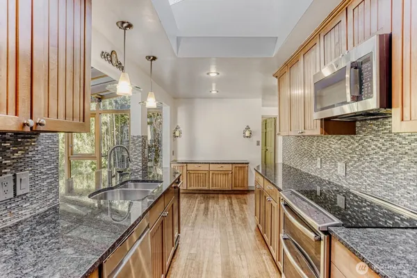 a spacious bathroom with a granite countertop double vanity