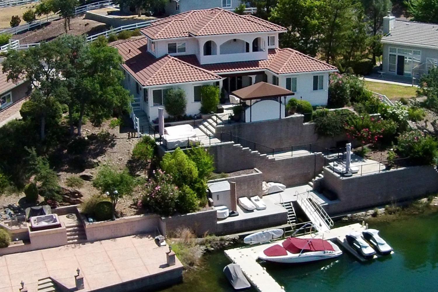 a front view of a house with yard and outdoor seating
