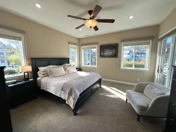 a bedroom with a bed couch and window