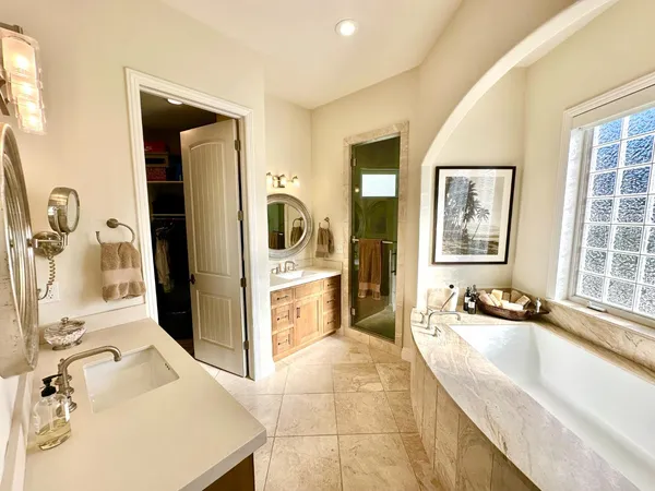a bathroom with a tub sink and mirror