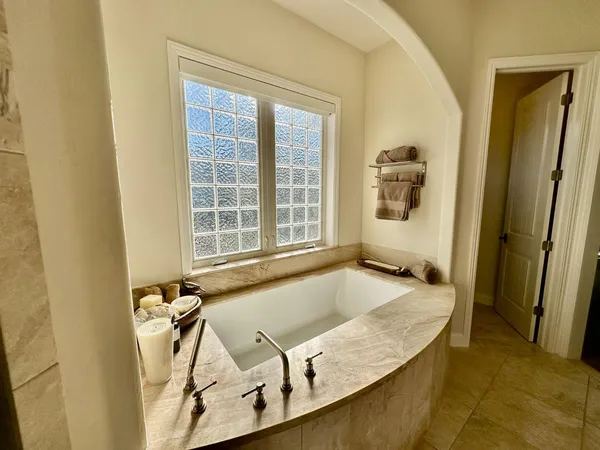 a bathroom with a tub and a window
