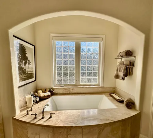 a view of a bathroom with a tub and sink
