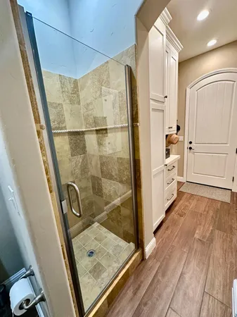 a bathroom with a sink and glass door shower