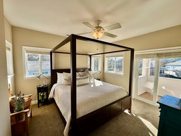 a bedroom with a bed and a large window