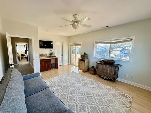 a living room with furniture a flat screen tv and a fireplace