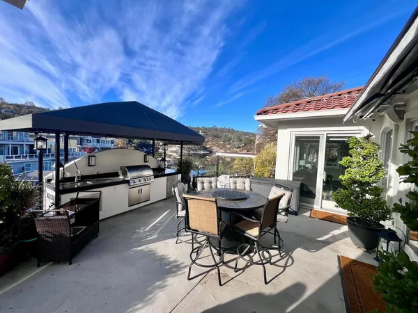 a view of a patio with table and chairs under an umbrella