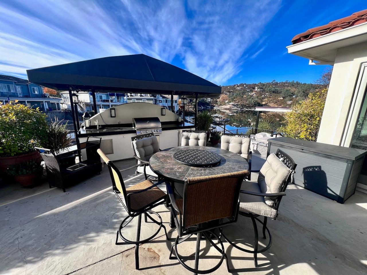 5 Paseo Delago Copperopolis, CA 95228 - Photo 29 of 39 a patio with a table and chairs under an umbrella