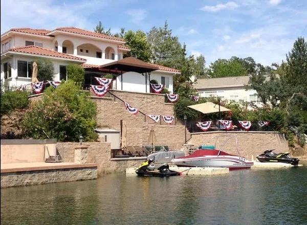 an aerial view of a house with swimming pool and outdoor seating