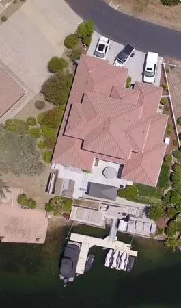 an aerial view of a house with a yard