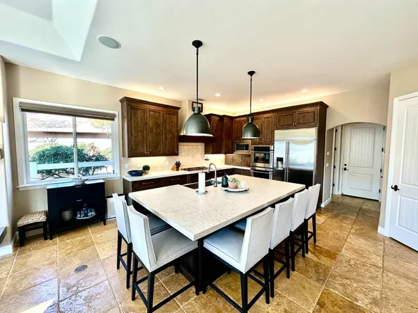 a large kitchen with a table and chairs