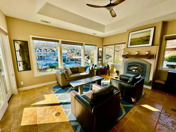 a living room with furniture a flat screen tv and a fireplace