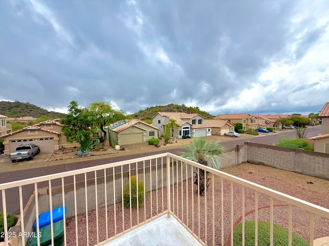 a front view of a house with a yard and potted plants