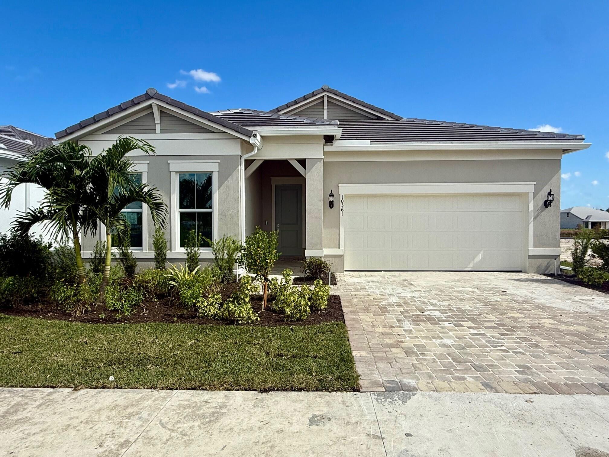 10361 Southwest Highpointe Drive, Unit PRESTIGE 268 Stuart, FL 34997 - Photo 1 of 24 a front view of a house with a garden