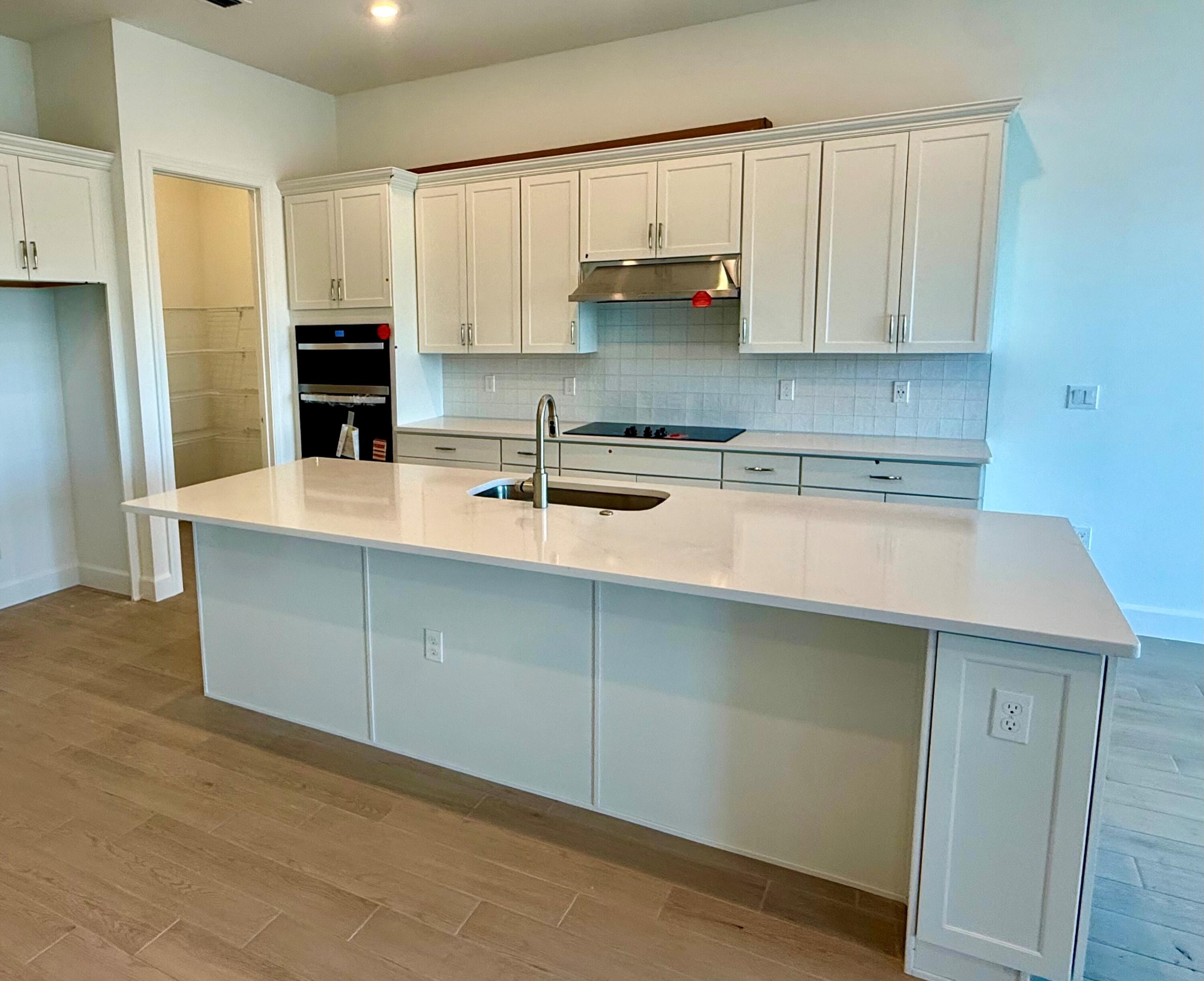 10361 Southwest Highpointe Drive, Unit PRESTIGE 268 Stuart, FL 34997 - Photo 5 of 24 a kitchen with stainless steel appliances granite countertop a sink a stove and refrigerator