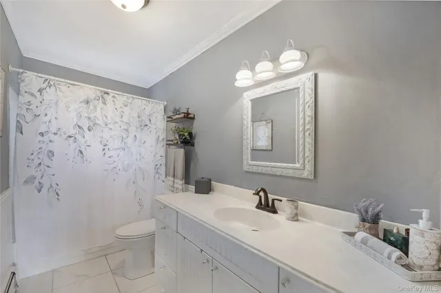 a bathroom with a sink vanity mirror and toilet